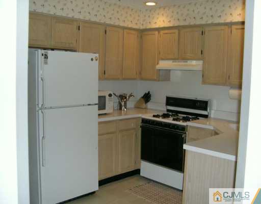 168 Nebula Road Piscataway, NJ 08854 - Photo 3 of 8 a white refrigerator freezer sitting inside of a kitchen