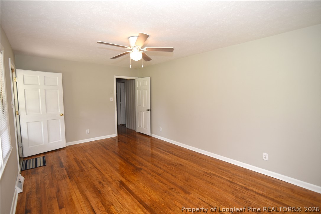 1673 Norment Road Lumberton, NC 28360 - Photo 4 of 32 an empty room with wooden floor fan and windows