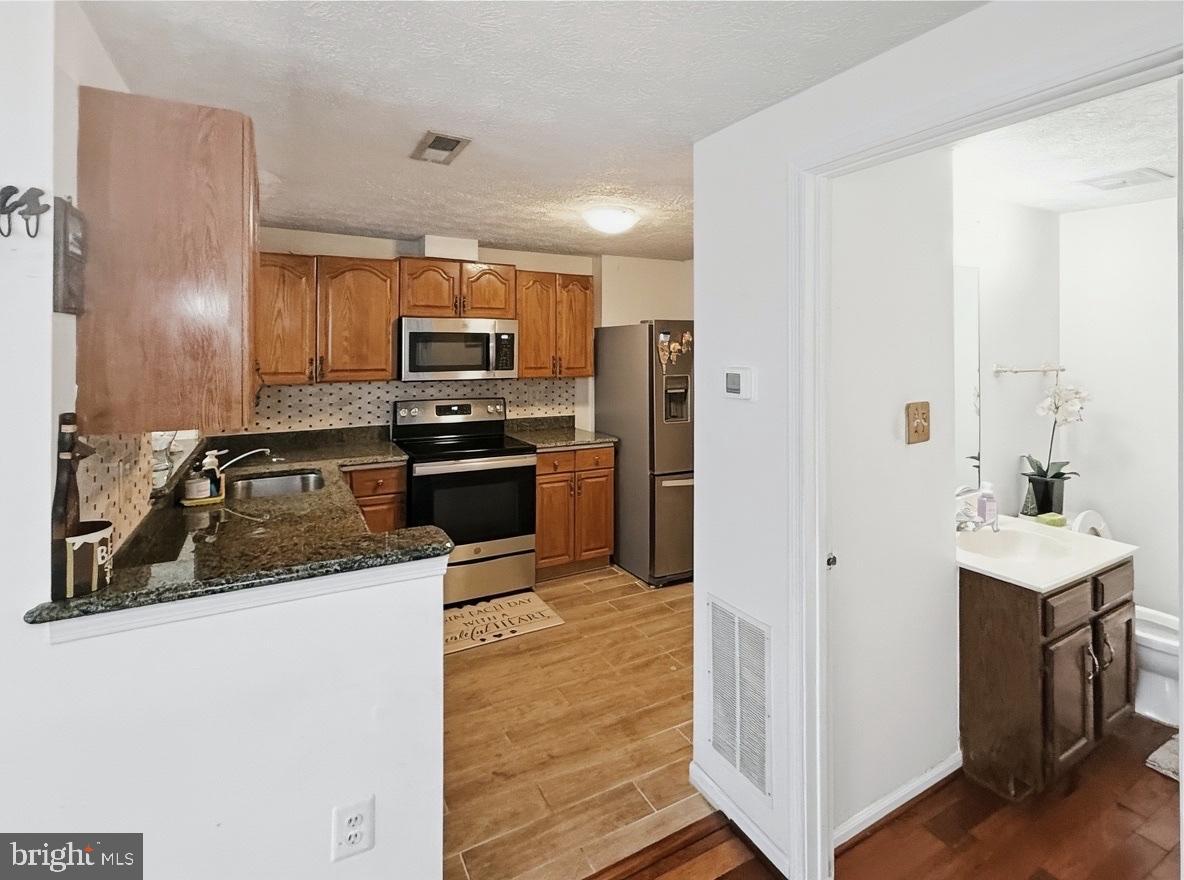 14106 Aldora Circle Silver Spring, MD 20904 - Photo 5 of 25 Modern kitchen with stone tile floor