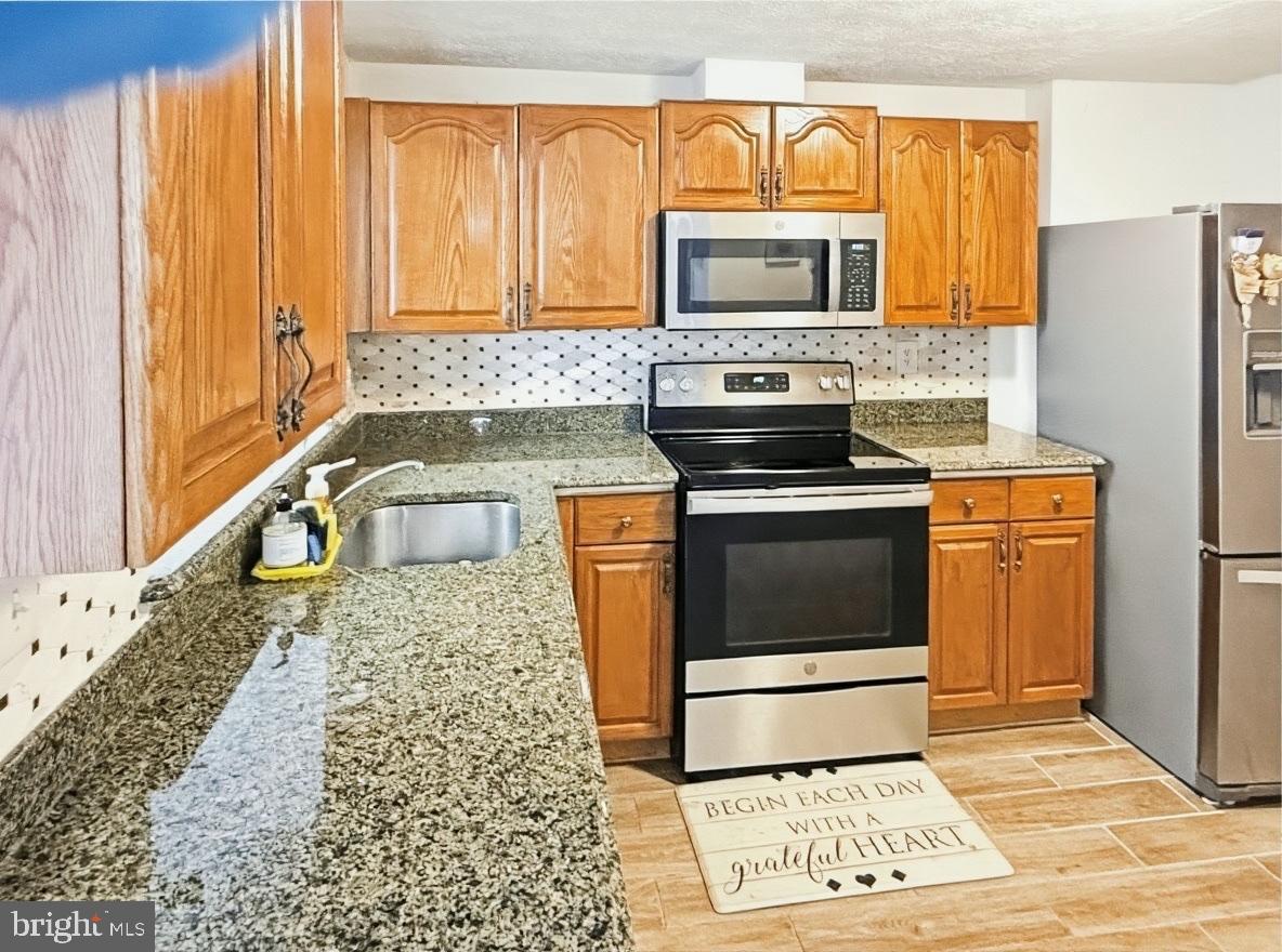 14106 Aldora Circle Silver Spring, MD 20904 - Photo 7 of 25 Modern kitchen with warm granite countertops