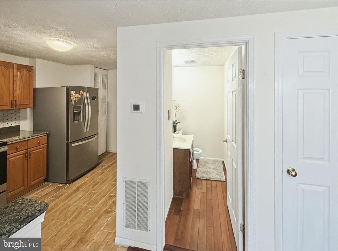 14106 Aldora Circle Silver Spring, MD 20904 - Photo 8 of 25 Modern kitchen with seamless flow to half bath.