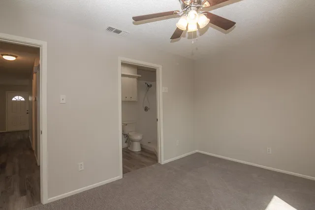 an empty room and chandelier fan in a kitchen