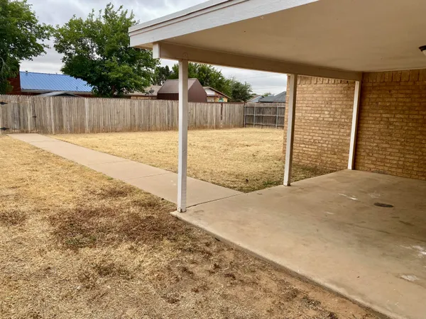a view of backyard with a swimming pool
