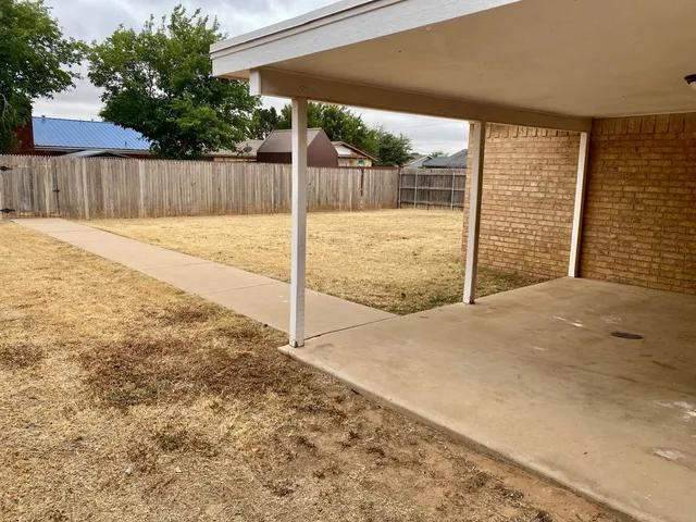 a view of backyard with a swimming pool