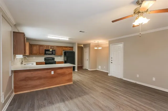 a large kitchen with kitchen island a sink stainless steel appliances and cabinets