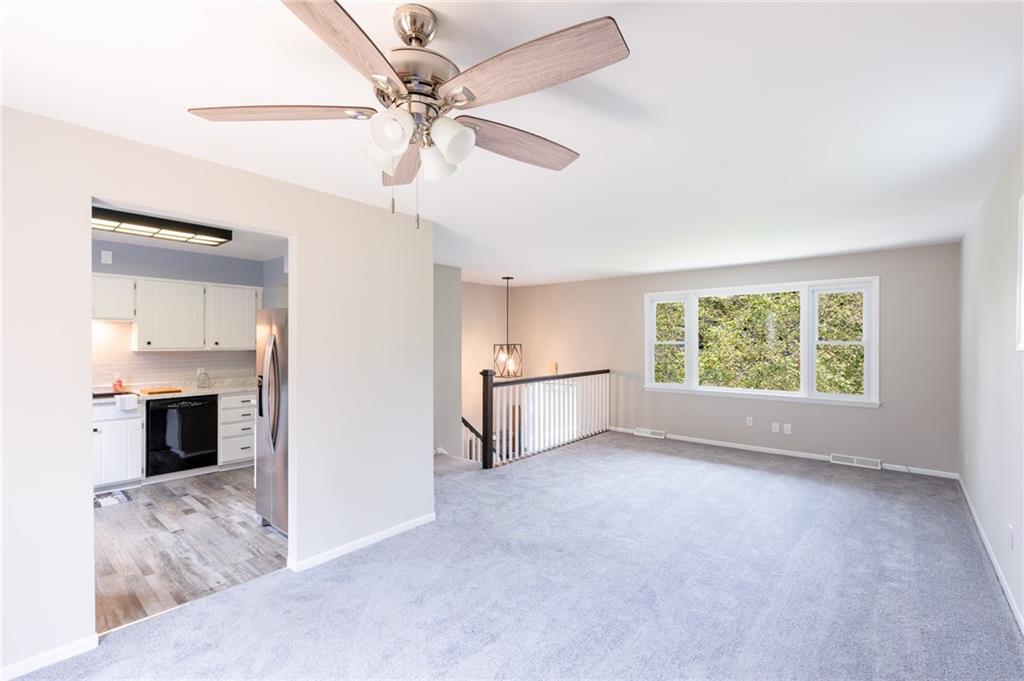 1929 Bakerstown Road Tarentum, PA 15084 - Photo 5 of 22 a view of a livingroom with a fireplace a ceiling fan and wooden floor