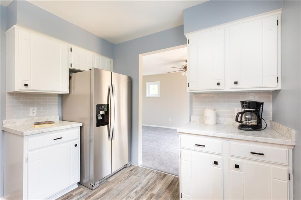 1929 Bakerstown Road Tarentum, PA 15084 - Photo 8 of 22 a kitchen with stainless steel appliances white cabinets and a refrigerator