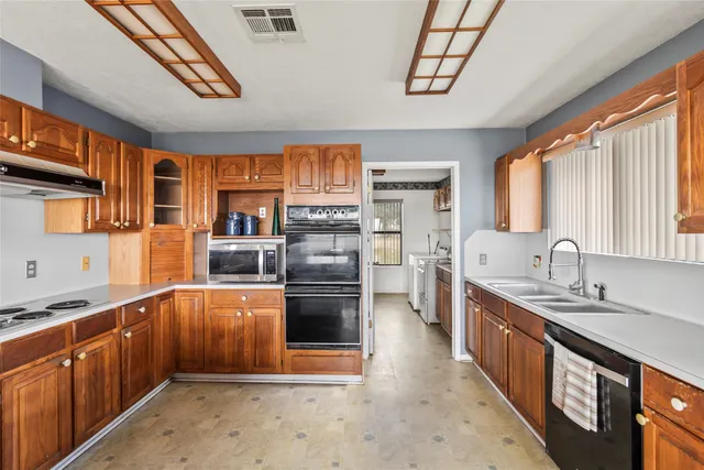 a open kitchen with stainless steel appliances granite countertop a stove a sink dishwasher and a refrigerator