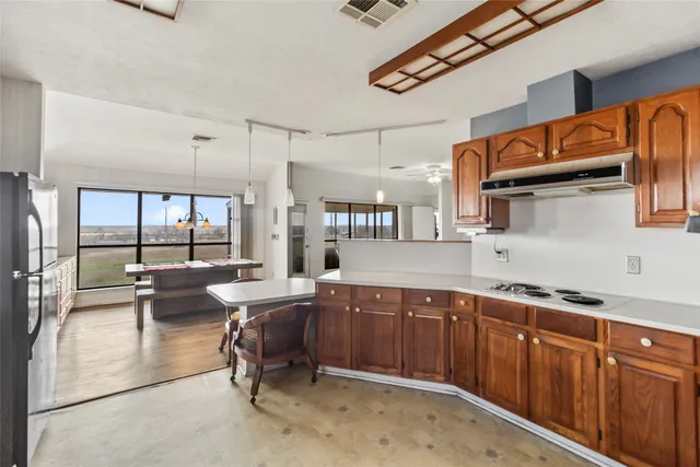 a kitchen with stainless steel appliances granite countertop a sink and cabinets