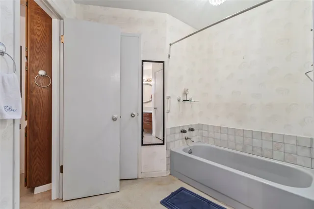 a bathroom with a bathtub and shower