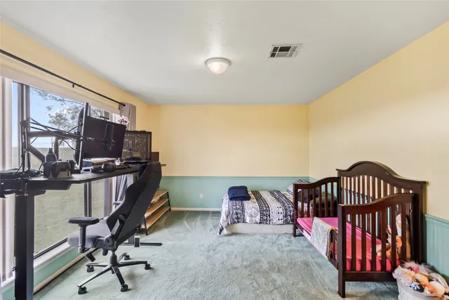 a bedroom with furniture and a window