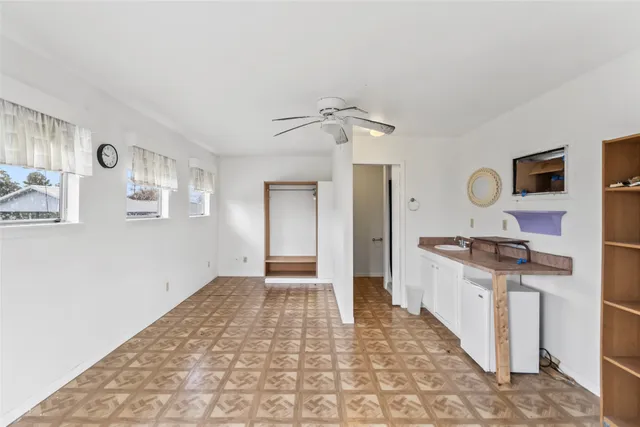 a view of a kitchen with a sink and a stove top oven