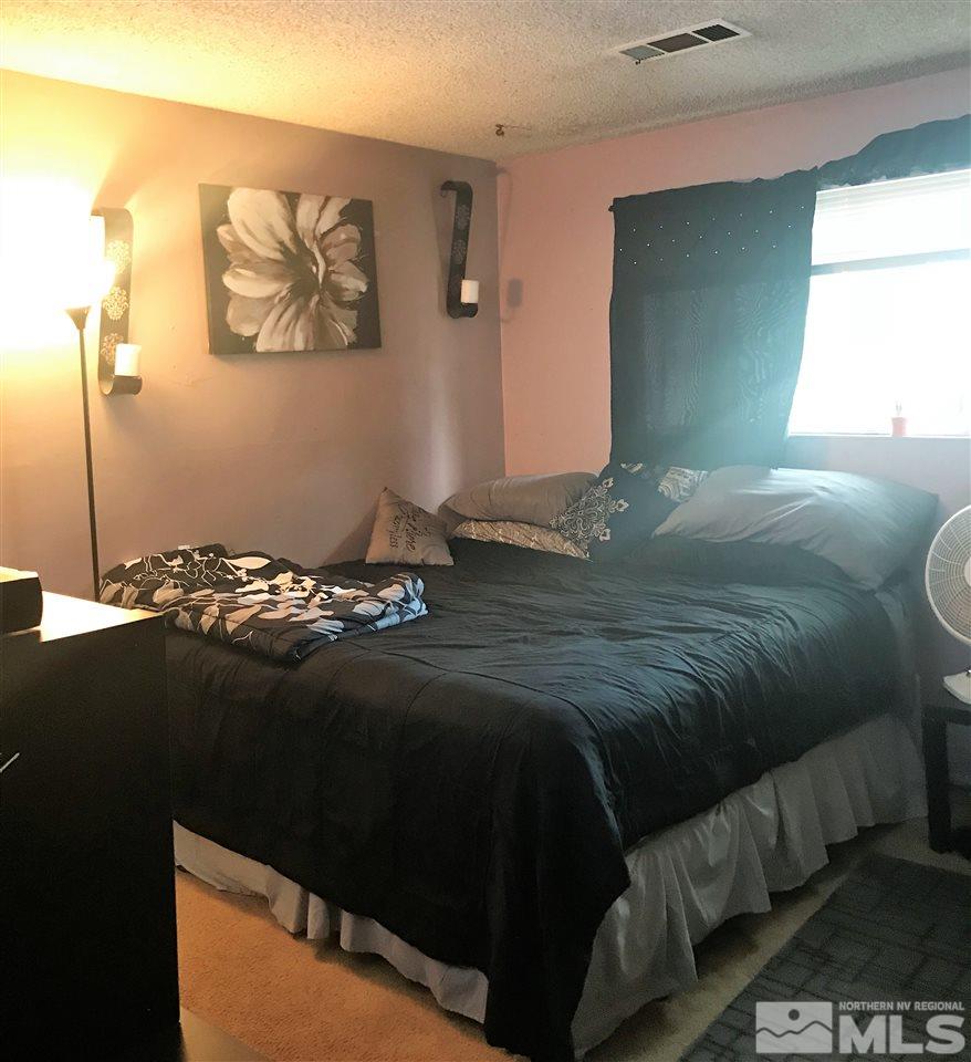 3551 Willow Reno, NV 89512 - Photo 9 of 15 a bed sitting in a bedroom next to a window