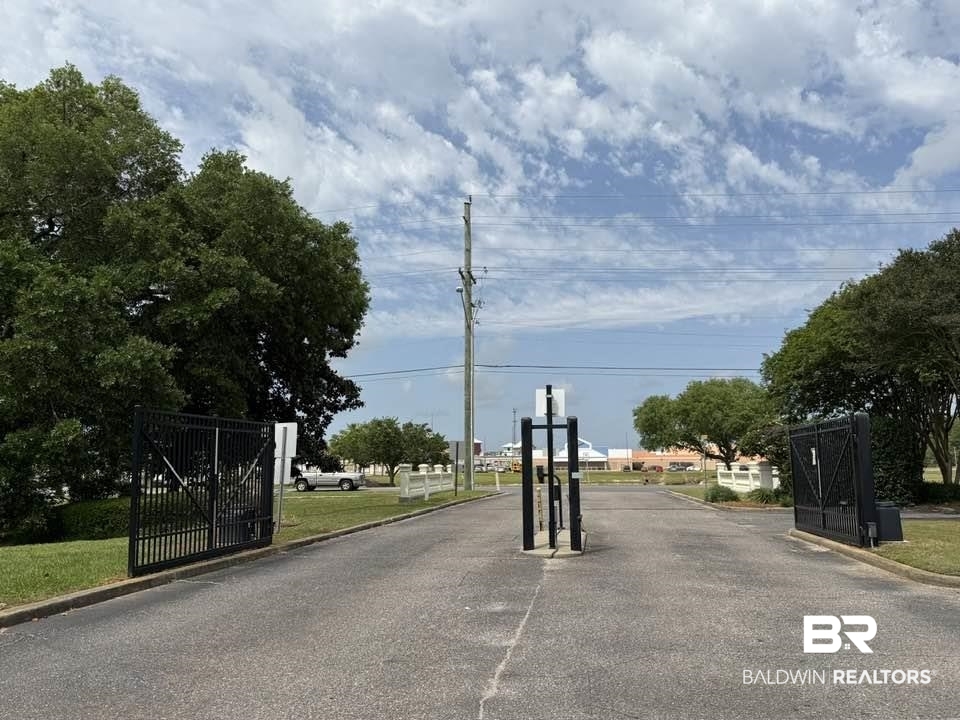 2651 South Juniper Street, Unit 401 Foley, AL 36535 - Photo 6 of 27 View of street with curbs, a gate, and a gated entry