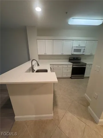 a kitchen with stainless steel appliances a sink stove and cabinets