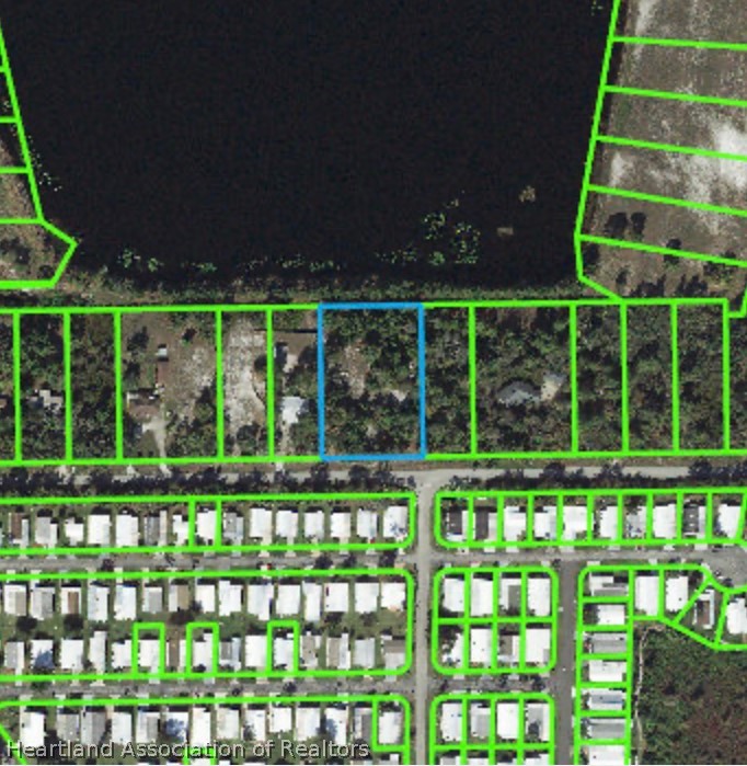 4366 Skipper Road Sebring, FL 33875 - Photo 2 of 2 a front view of a house with a big yard