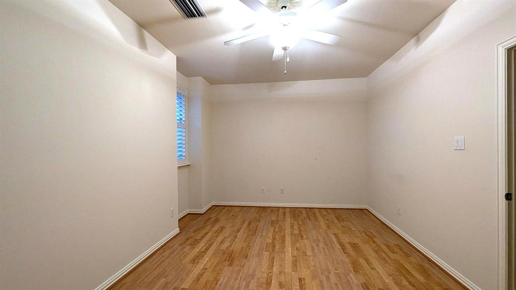 4209 Sexton Lane Dallas, TX 75229 - Photo 19 of 27 a view of a room with wooden floor and ceiling fan