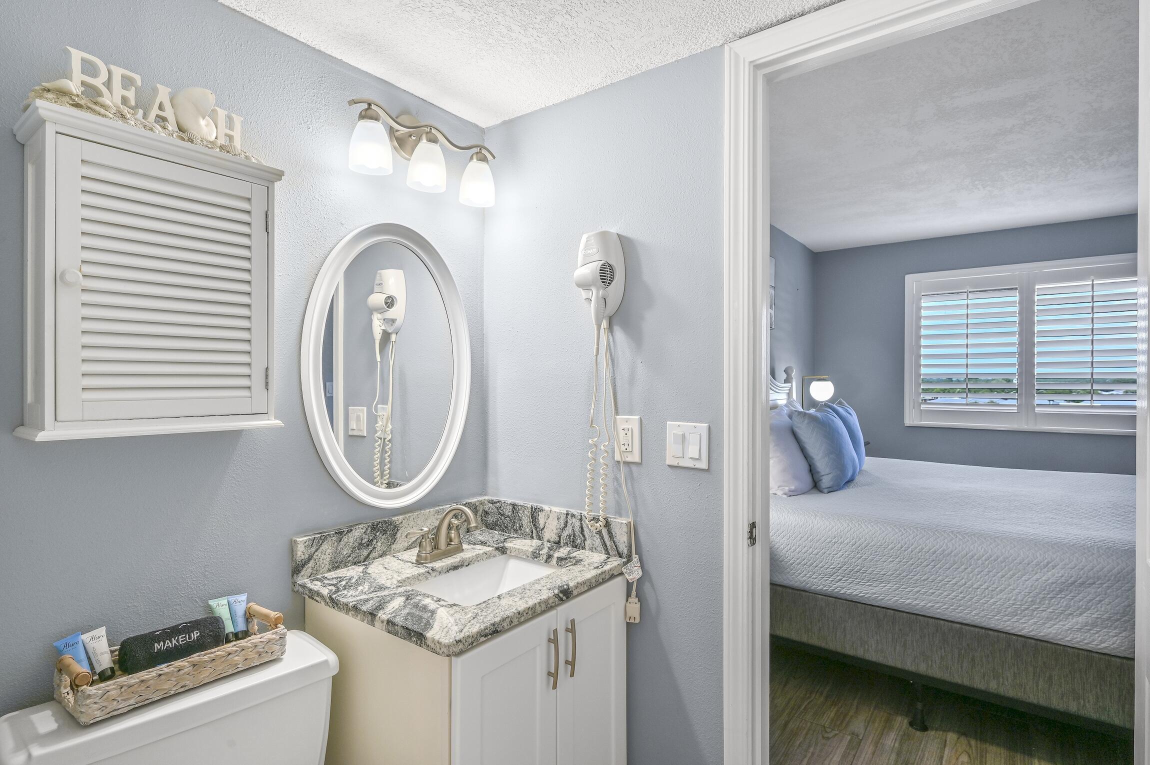 1040 Highway 98, Unit 802 Destin, FL 32541 - Photo 11 of 27 a bedroom with a bed and a mirror