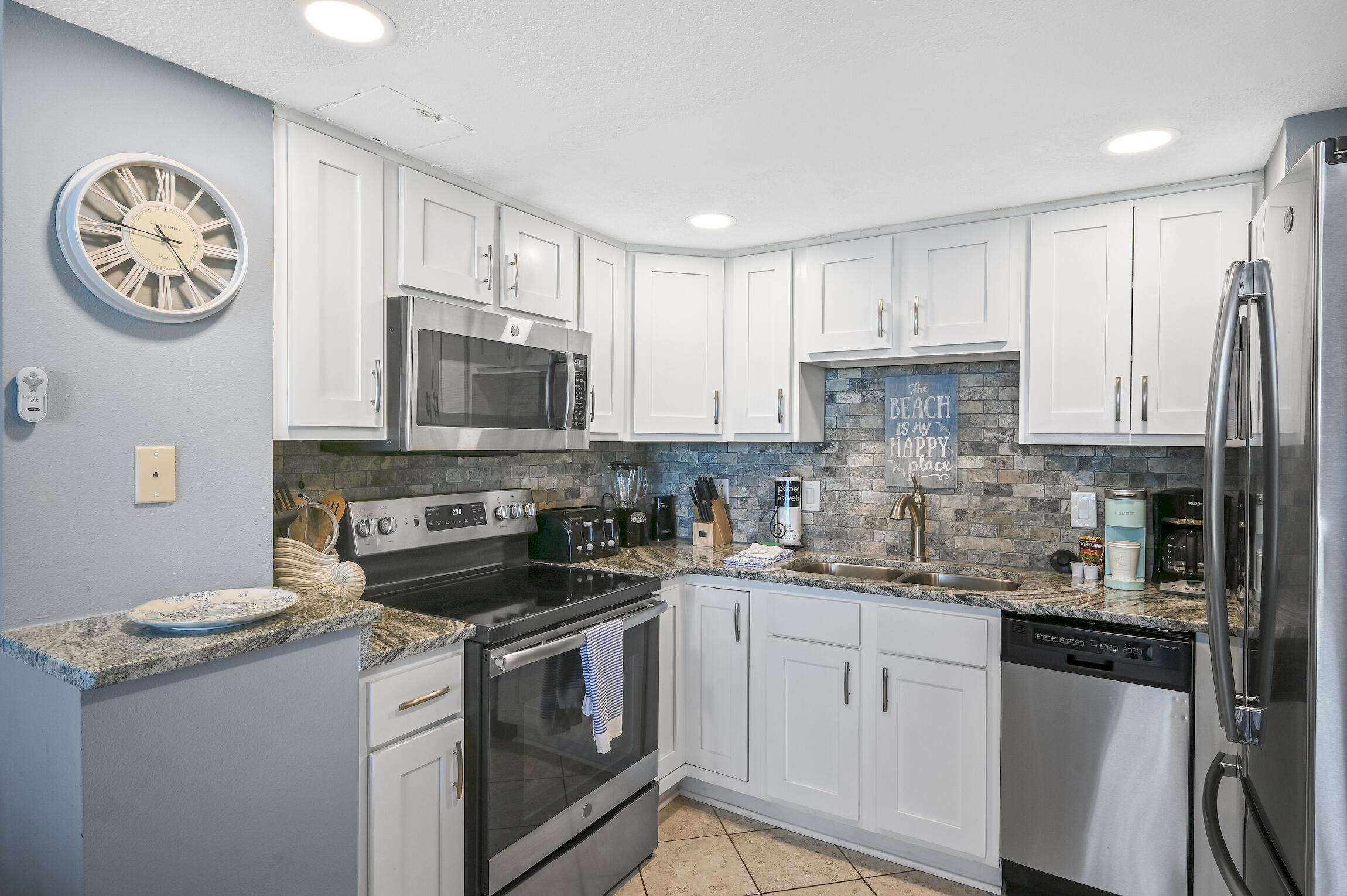 1040 Highway 98, Unit 802 Destin, FL 32541 - Photo 4 of 27 a kitchen with a sink a stove and cabinets