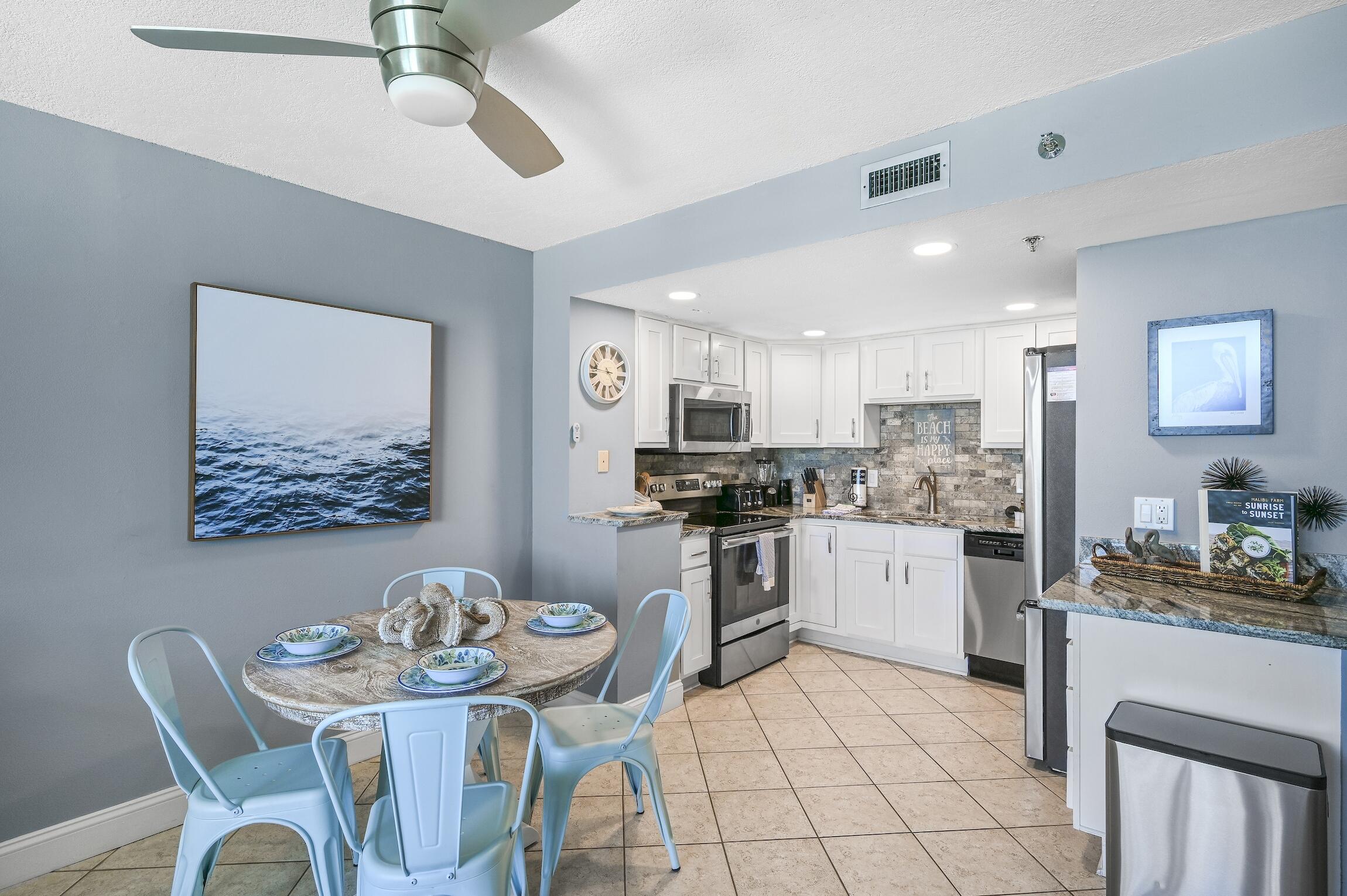 1040 Highway 98, Unit 802 Destin, FL 32541 - Photo 5 of 27 a kitchen with a white cabinets and chairs