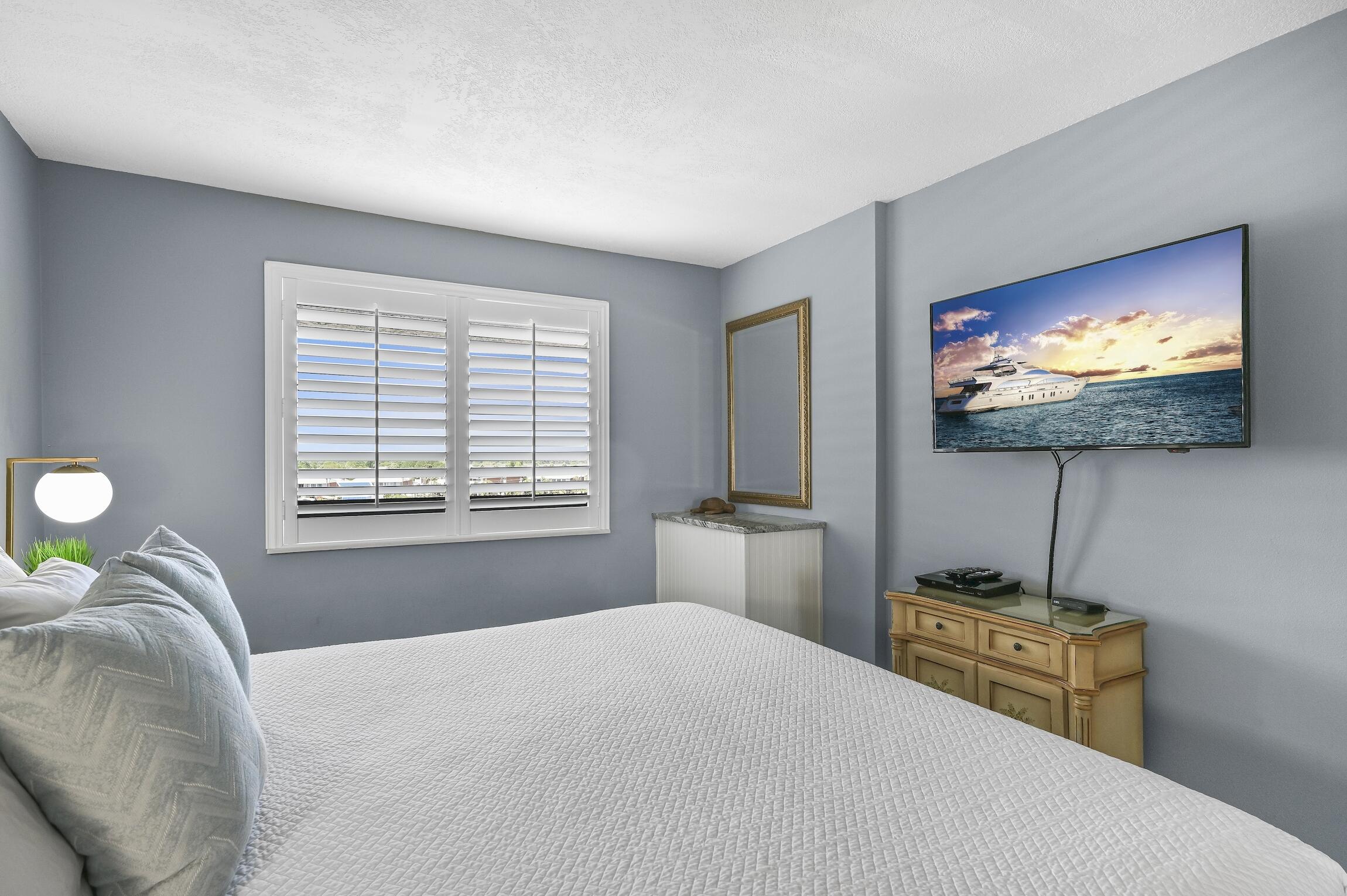 1040 Highway 98, Unit 802 Destin, FL 32541 - Photo 10 of 27 a bedroom with a bed and a flat screen tv
