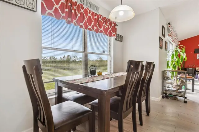 a view of a dining room with furniture window and outside view