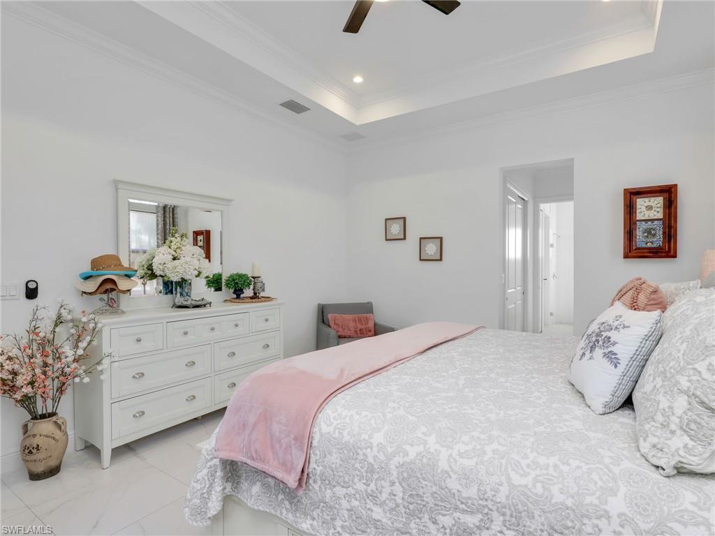 2007 22nd Avenue Northeast Naples, FL 34120 - Photo 17 of 47 Primary Bedroom With Tray Ceiling and Ceiling Fan