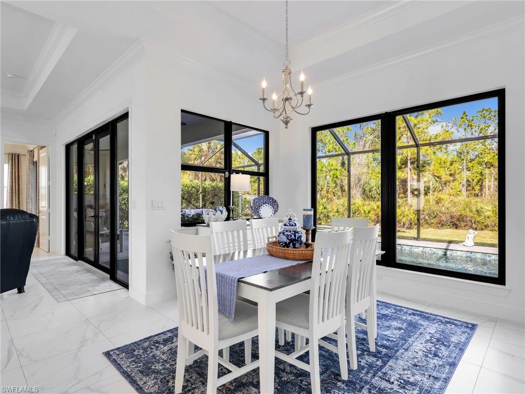 2007 22nd Avenue Northeast Naples, FL 34120 - Photo 10 of 47 Dining Area With Pool & Rear Yard Views