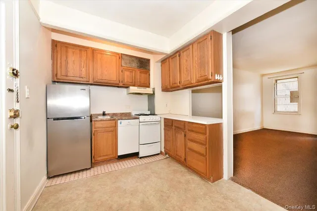 a kitchen with stainless steel appliances a refrigerator and a stove