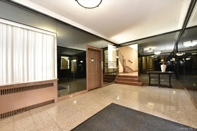 a view of a hallway with seating area