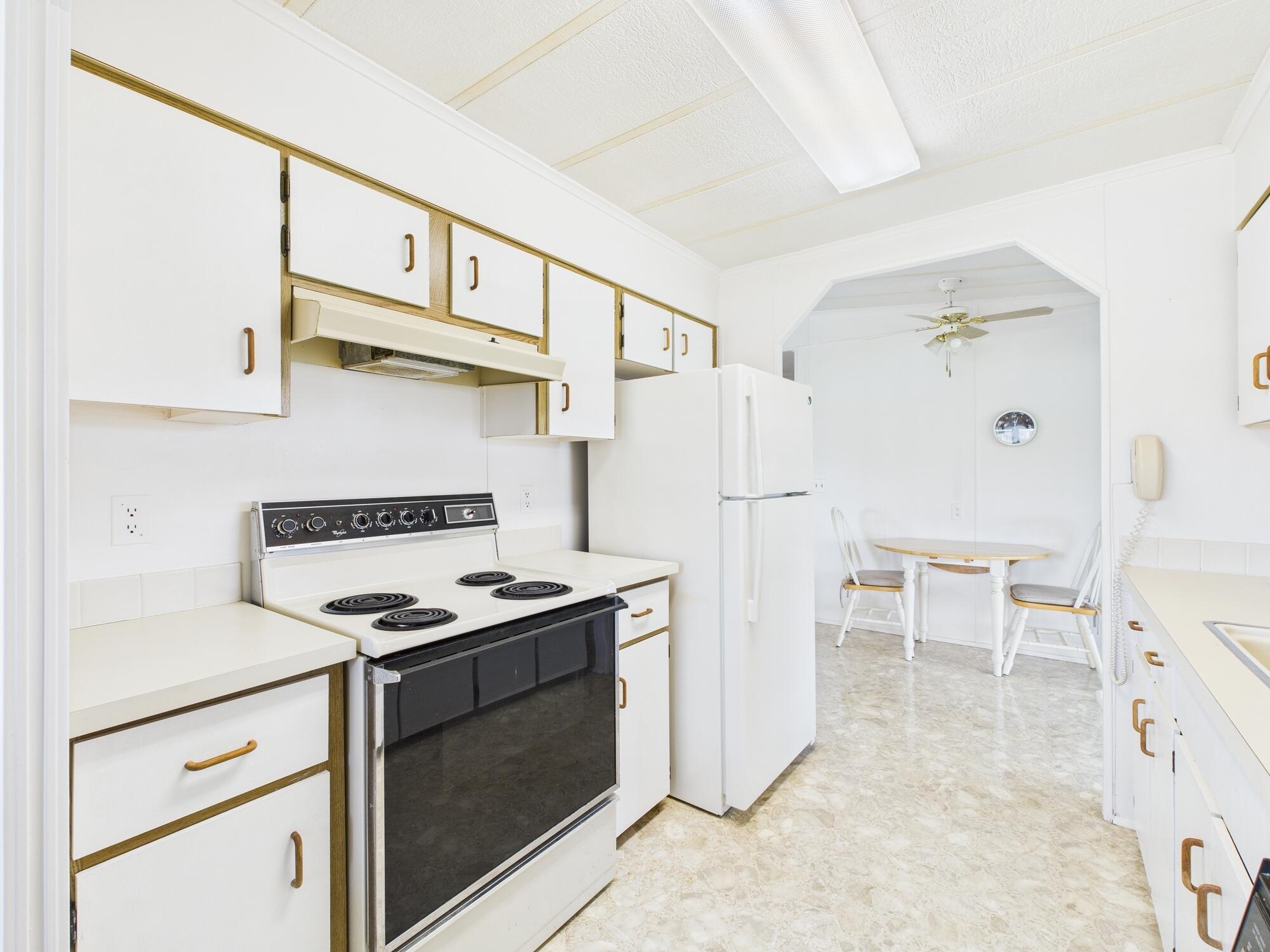 2001 Southeast 27th Street Okeechobee, FL 34974 - Photo 18 of 57 a kitchen with stainless steel appliances a refrigerator and a stove