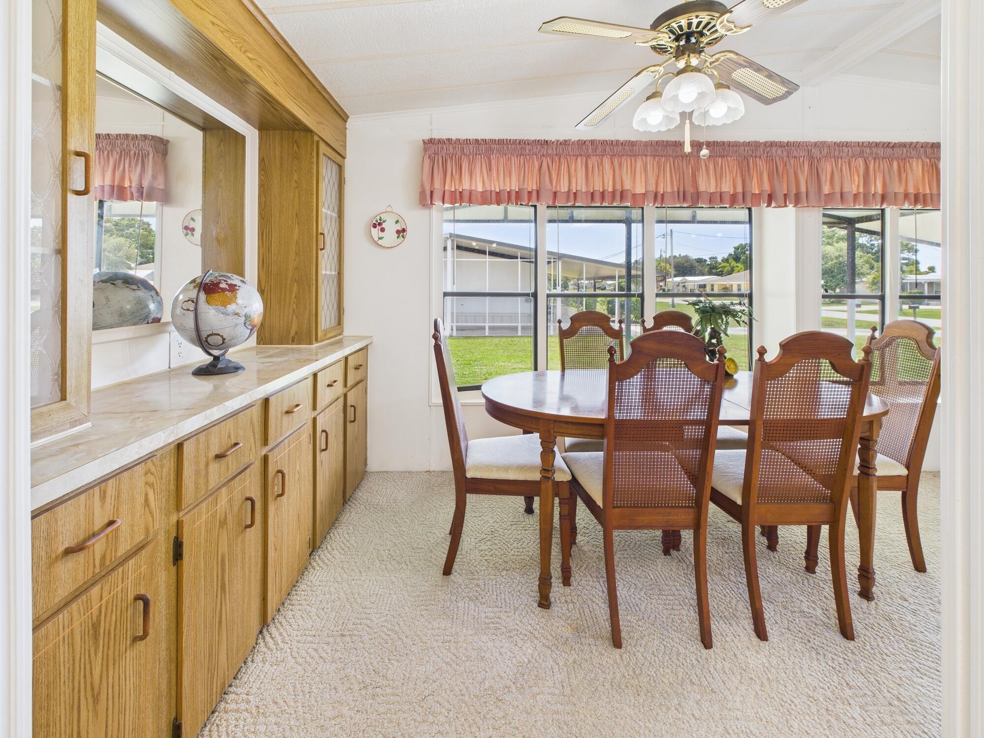 2001 Southeast 27th Street Okeechobee, FL 34974 - Photo 20 of 57 a view of a dining room with furniture wooden floor and chandelier
