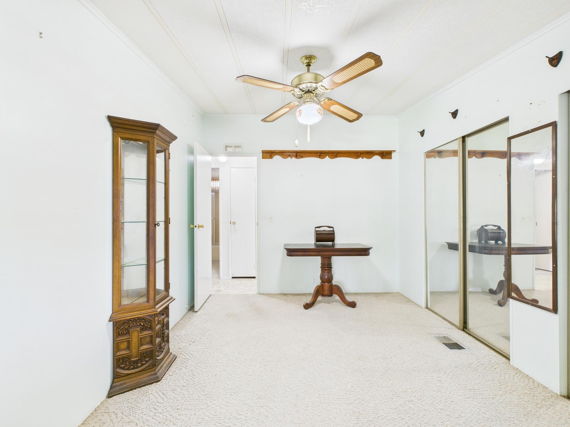 2001 Southeast 27th Street Okeechobee, FL 34974 - Photo 27 of 57 a living room with hardwood floor and a ceiling fan