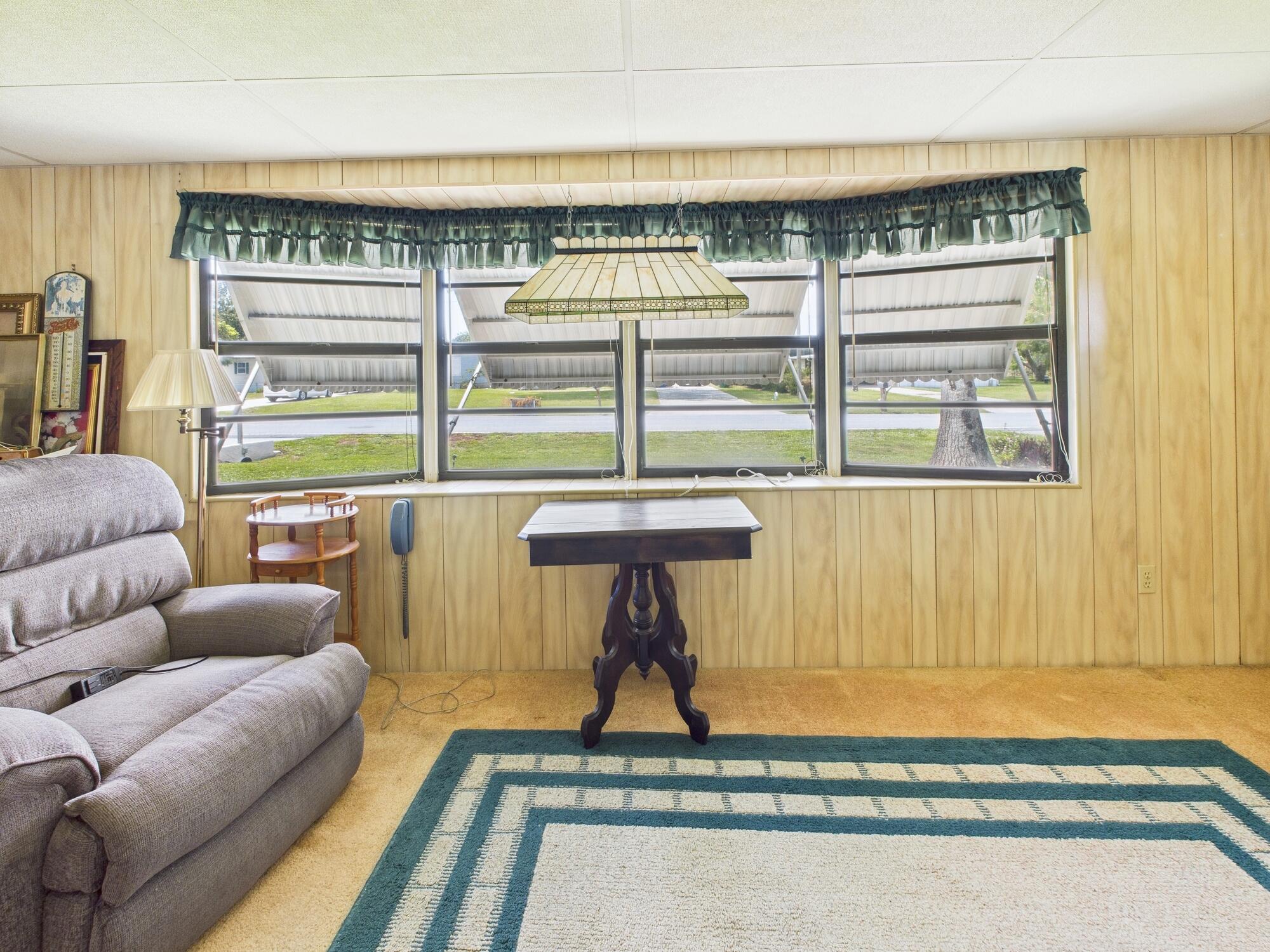 2001 Southeast 27th Street Okeechobee, FL 34974 - Photo 31 of 57 a living room with furniture a window and a rug