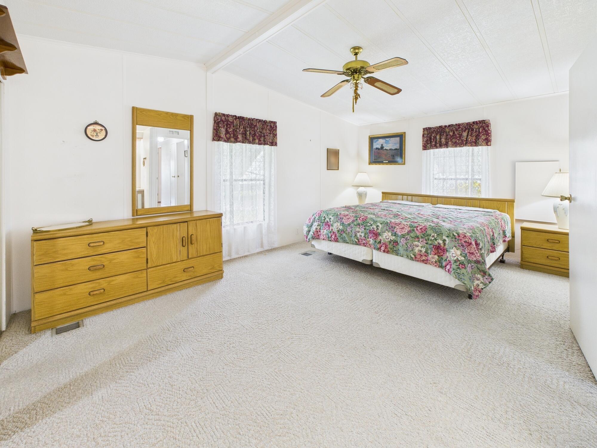 2001 Southeast 27th Street Okeechobee, FL 34974 - Photo 37 of 57 a bedroom with a bed and a chandelier