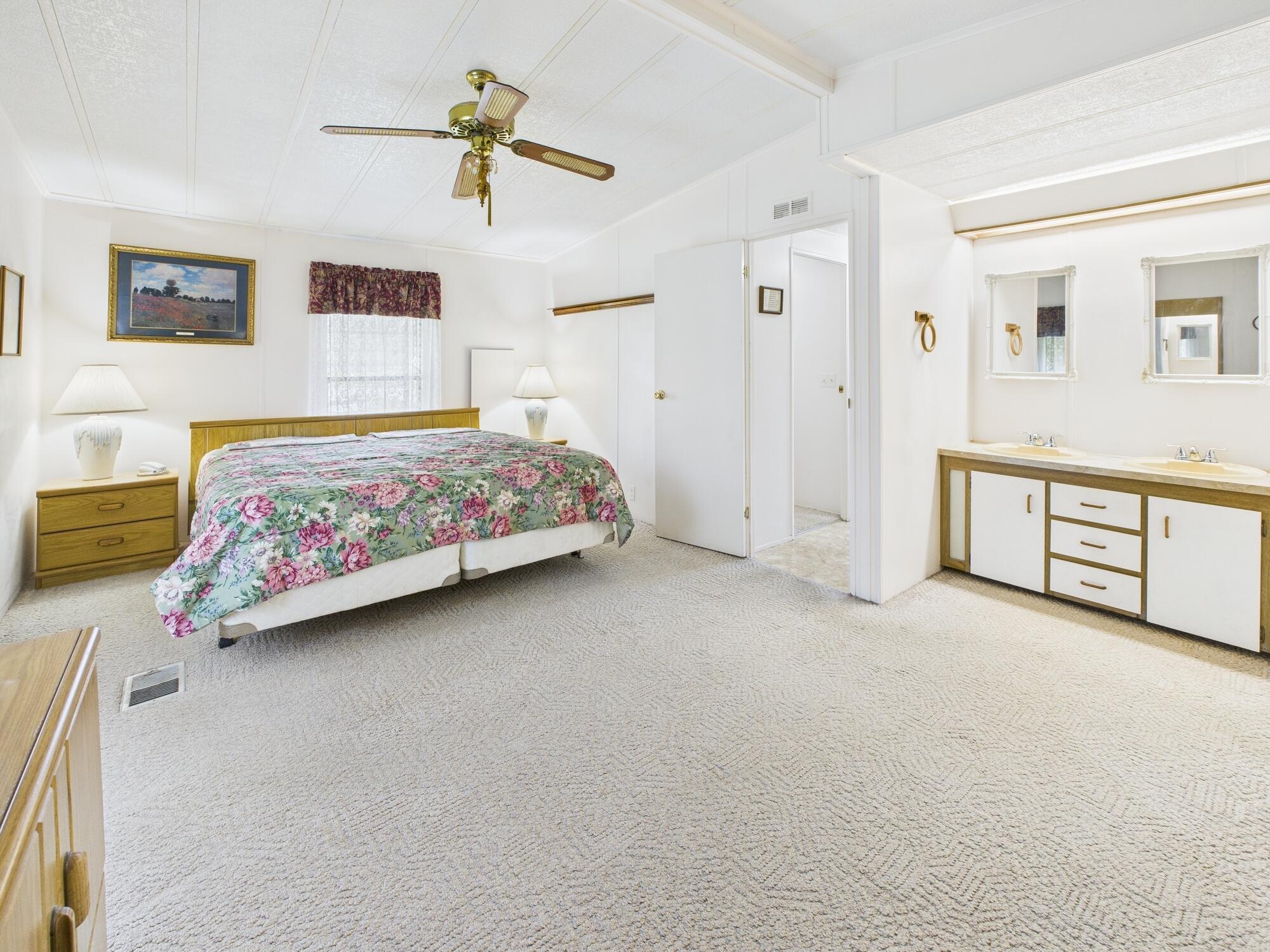 2001 Southeast 27th Street Okeechobee, FL 34974 - Photo 39 of 57 a bedroom with a bed and a chandelier