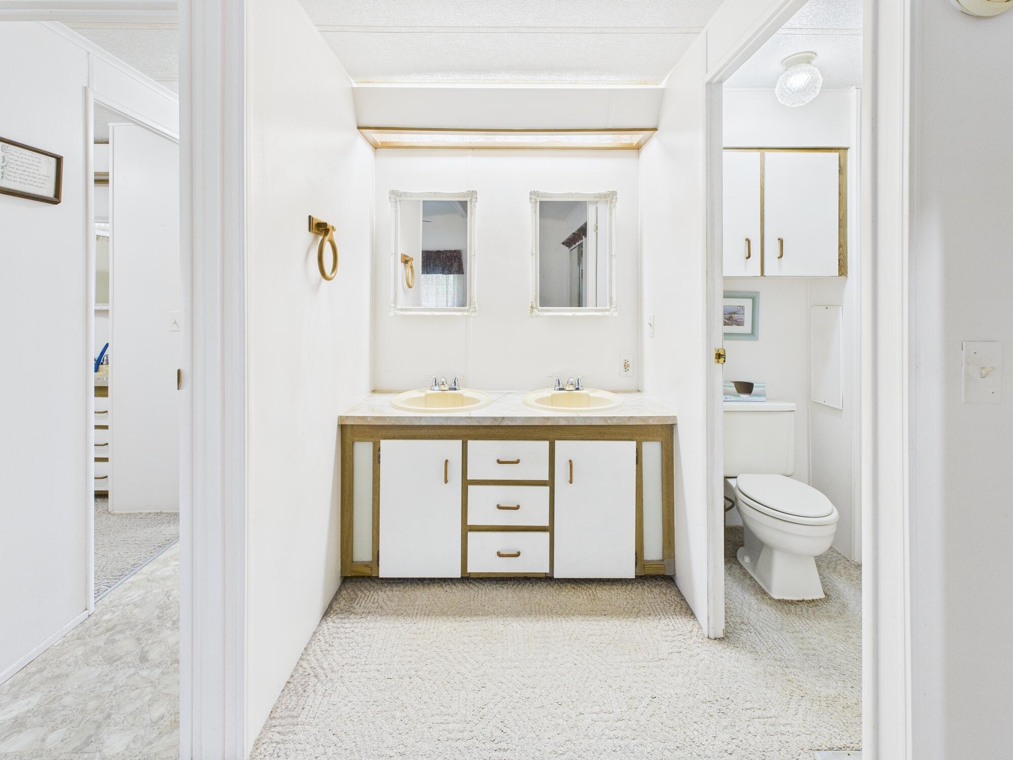2001 Southeast 27th Street Okeechobee, FL 34974 - Photo 40 of 57 a bathroom with a toilet a sink and a mirror