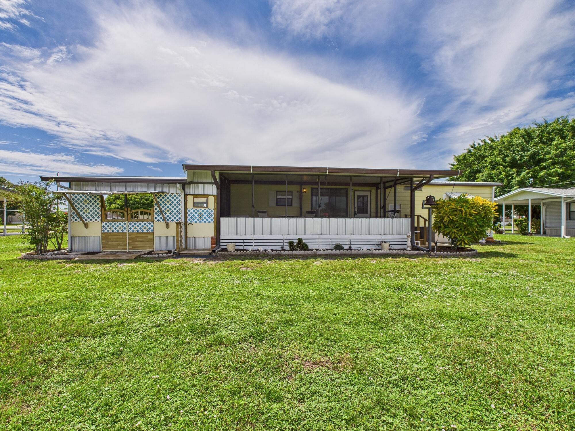 2001 Southeast 27th Street Okeechobee, FL 34974 - Photo 48 of 57 front view of a house with a garden