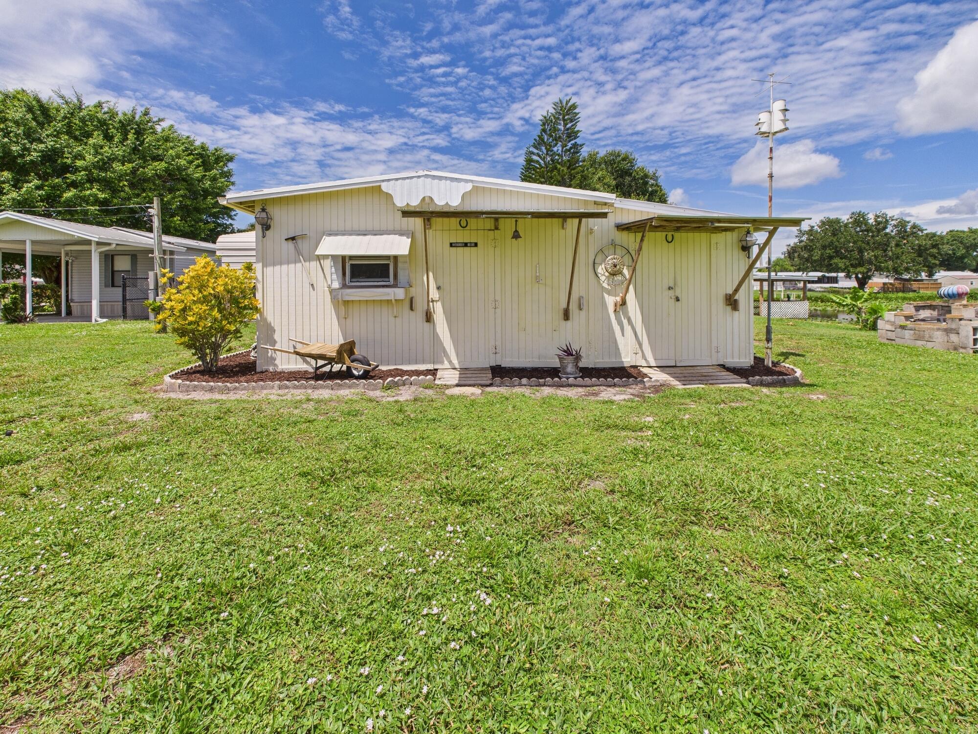 2001 Southeast 27th Street Okeechobee, FL 34974 - Photo 50 of 57 a front view of a house with garden