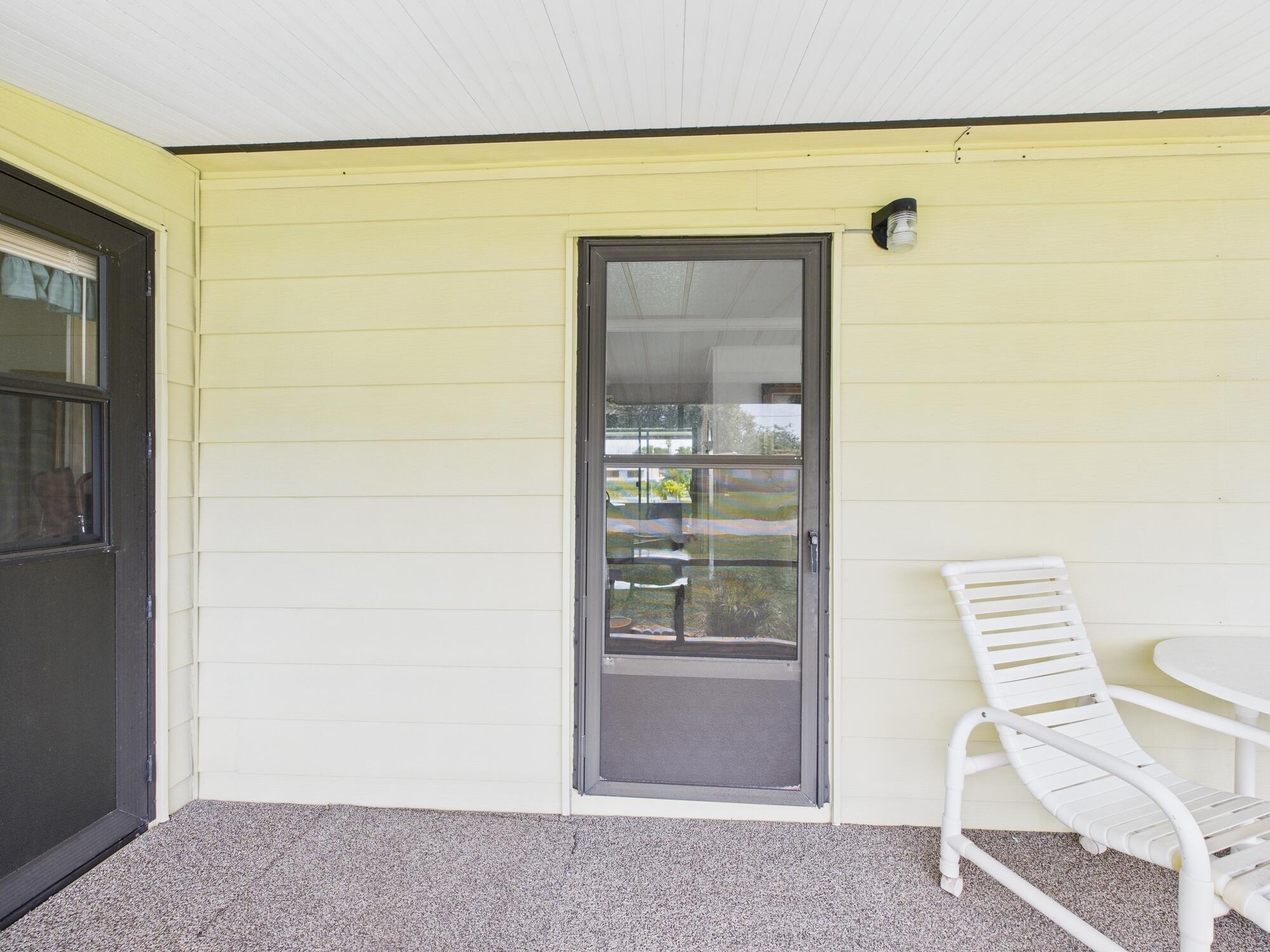 2001 Southeast 27th Street Okeechobee, FL 34974 - Photo 9 of 57 a view of room with wooden floor and chair