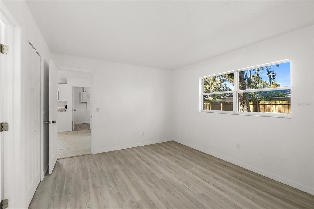 145 Oak Ridge Avenue Edgewater, FL 32132 - Photo 13 of 32 a view of empty room with wooden floor and windows