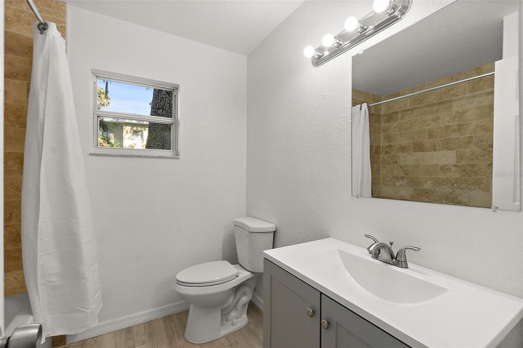 145 Oak Ridge Avenue Edgewater, FL 32132 - Photo 18 of 32 a bathroom with a toilet a sink and mirror