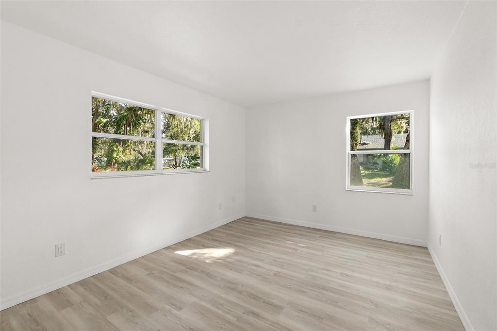 145 Oak Ridge Avenue Edgewater, FL 32132 - Photo 20 of 32 an empty room with wooden floor and window