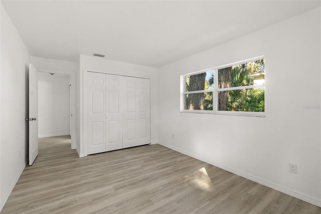 145 Oak Ridge Avenue Edgewater, FL 32132 - Photo 21 of 32 an empty room with wooden floor and windows