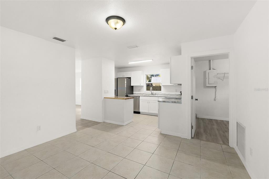 145 Oak Ridge Avenue Edgewater, FL 32132 - Photo 6 of 32 a kitchen with white cabinets a sink and appliances