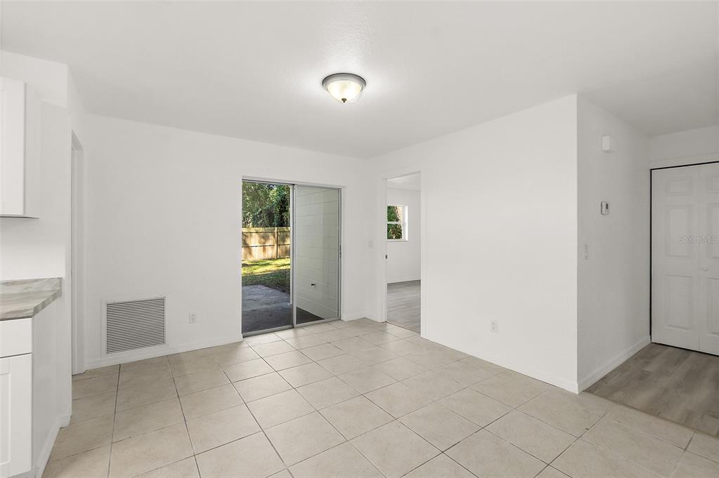 145 Oak Ridge Avenue Edgewater, FL 32132 - Photo 7 of 32 a view of an empty room with window and stairs
