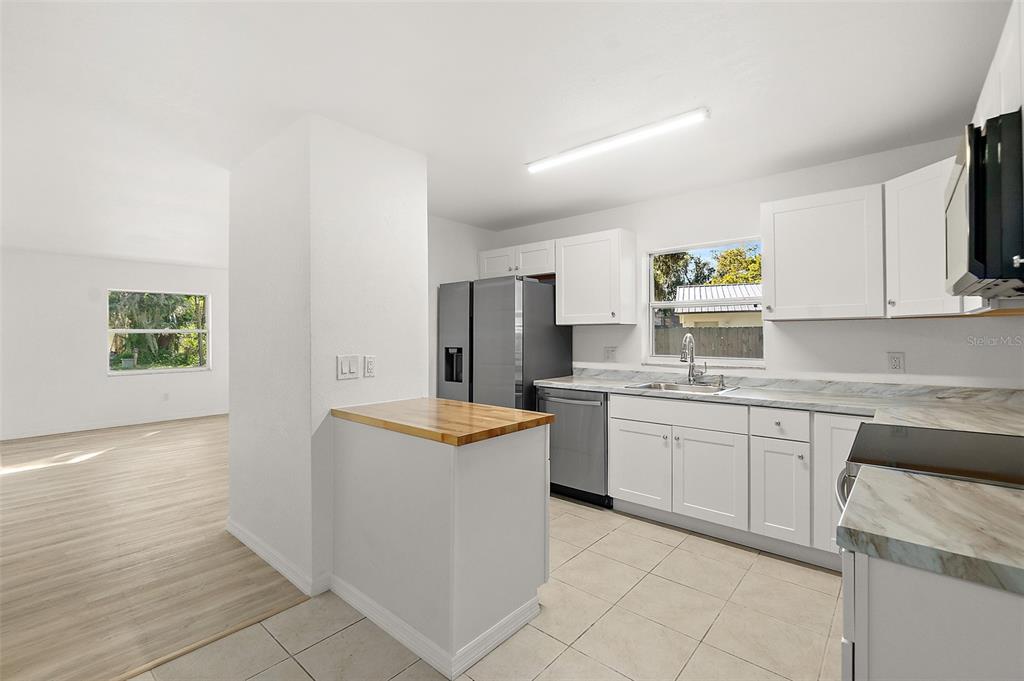 145 Oak Ridge Avenue Edgewater, FL 32132 - Photo 8 of 32 a kitchen with stainless steel appliances granite countertop a sink and a stove