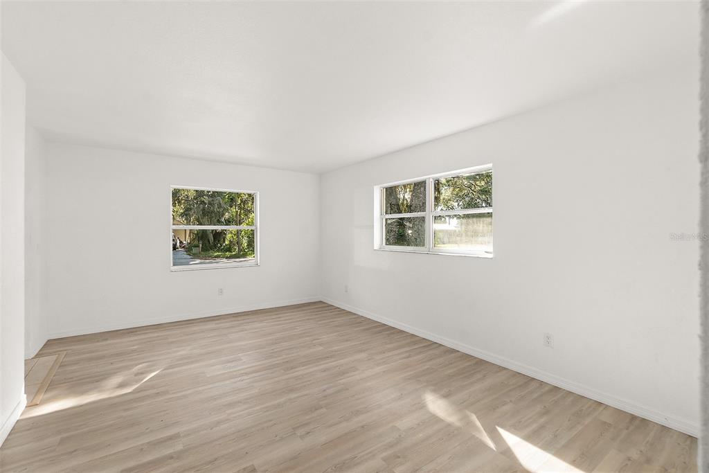 145 Oak Ridge Avenue Edgewater, FL 32132 - Photo 9 of 32 an empty room with windows