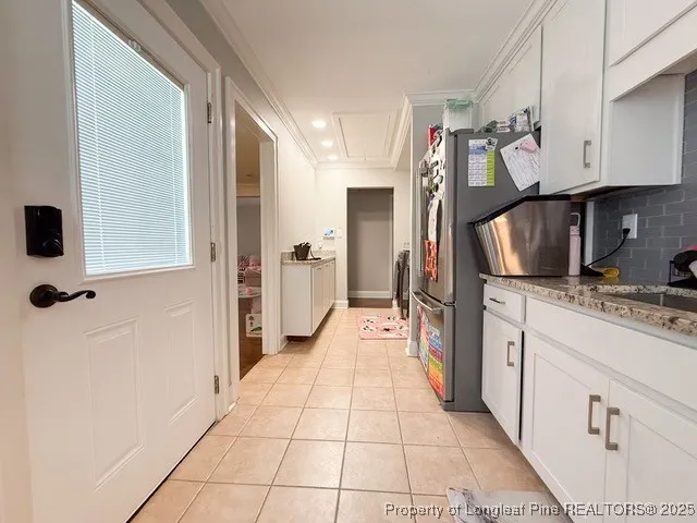 a kitchen with stainless steel appliances granite countertop a refrigerator and a stove
