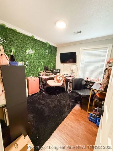 a living room with furniture a flat screen tv and a large window